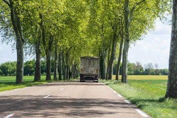Old truck running in country lane, Northern France