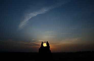 Silhouette of two friends at Tughlakabad Fort Delhi 