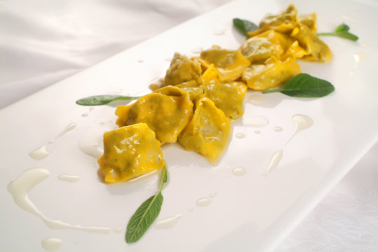 Italian food recipes, fresh stuffed pasta Agnolotti del plin with butter and sage sauce.