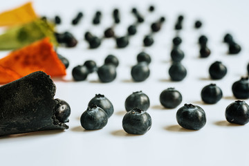 Ripe blueberries lined up in an empty ice cream cone, healthy desserts in summer, isolated on white background with copy space.