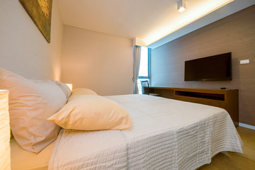 Luxury bedroom interior with large comfortable bed. Space for text 