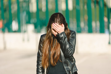 Fototapeta premium Sad teen girl millennial woman feeling heartbroken at phone, depressed upset by bad news in mobile feeling anxious.