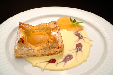 Italian food recipes, traditional  dessert Sfogliatella with peach and egg cream.