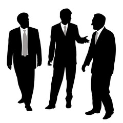 Group of three businessmen walking and talking