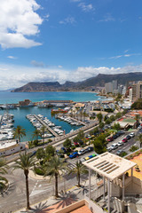 Naklejka premium Calp Spain coast town and marina known for the famous rock landmark Penon de Ilfach