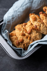 cookies with nuts on baking dish gray background close up