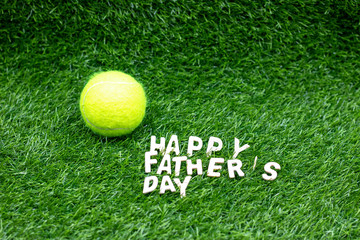Happy Father's day to tennis player with tennis ball on green grass
