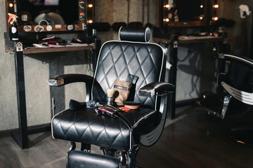 Vintage barber shop hairdresser tools equipment on leather chair background