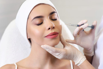 Beautician doctor cosmetologist at work. Biorevitalization cosmetology injection. Face skin treatment hyaluronic acid. Beauty facial filling. Filler. Botox procedure. Healthcare beauty concept - obrazy, fototapety, plakaty