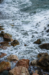Seascape of dramatic storm, sea waves on wild rocky seashore