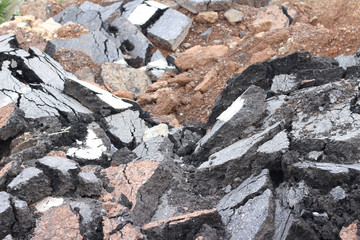 pieces of asphalt road on the ground to be recycled.