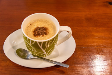 Cappuccino coffee on dark wood table 
