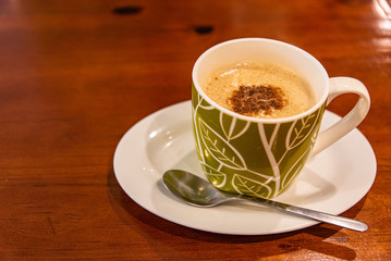 Cappuccino coffee on dark wood table 