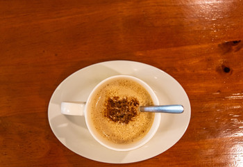 Cappuccino coffee on dark wood table 