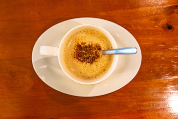 Cappuccino coffee on dark wood table 