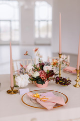 Wedding decoration table in the hall, floral arrangement. In the style vintage. Decorated dining table with flowers for guests and newlyweds, in peach-pink & pastel color. Beautiful table setting.