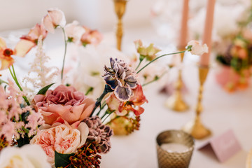 Wedding decoration table in the hall, floral arrangement. In the style vintage. Decorated dining...