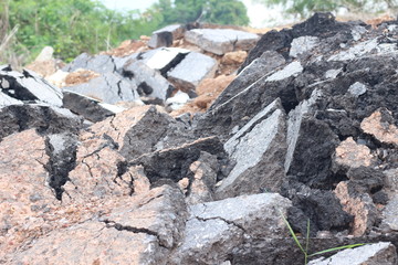 pieces of asphalt road on the ground to be recycled.