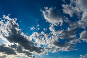 Clouds in bright sunlight. Nimbostratus clouds in sunlight. Blue sky and white clouds in bright sunlight.