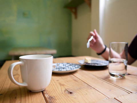 Coffee and cake at a wooden table in a hippster cafe