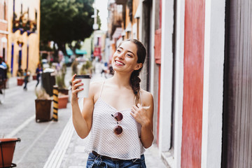 young latin woman holding a cup of coffee or tea, mexican girl in mexico