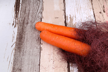 Bunch of fresh carrots over vintage wood background.