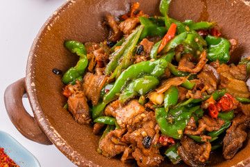 A dish of spicy Hunan cuisine in white background