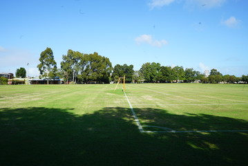 an empty green park with a soccer field