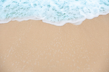 Bubble blue wave from sea to sand on the beach.summer background.top view.