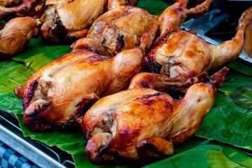 BAKE CHICKEN - STREET FOOD : BAKE WHOLE CHICKEN LAYING ON GREEN BANANA LEAF - HALAL FOOD