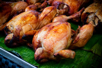 BAKE CHICKEN - STREET FOOD : BAKE WHOLE CHICKEN LAYING ON GREEN BANANA LEAF - HALAL FOOD