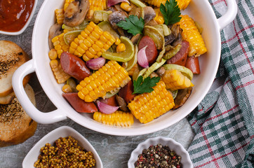 Slices of fried vegetables with sausages