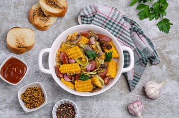 Slices of fried vegetables with sausages