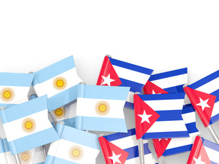 Pins with flags of Argentina and cuba isolated on white.