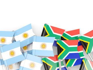 Pins with flags of Argentina and south africa isolated on white.