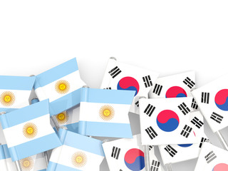 Pins with flags of Argentina and south korea isolated on white.