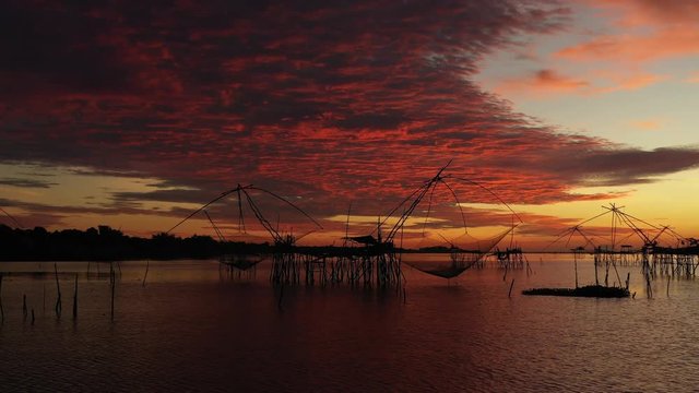 View sunrise at Sri Pak Pra fishing traditional local fishing trap with silhouette