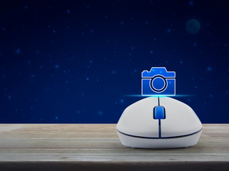 Camera icon with wireless computer mouse on wooden table over fantasy night sky and moon, Camera shop online concept