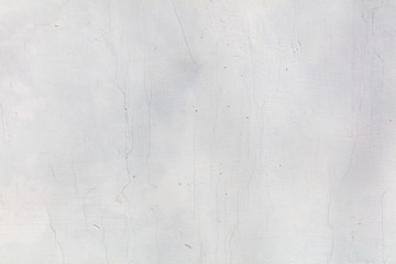 White wall with cracked plaster as abstract background