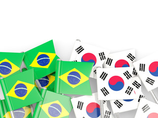 Pins with flags of Brazil and south korea isolated on white.