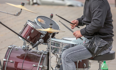 Man playing drums at a concert in the park