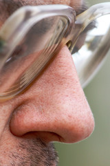 Glasses in front of a man