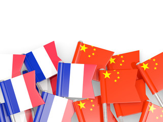 Fototapeta na wymiar Pins with flags of France and china isolated on white.
