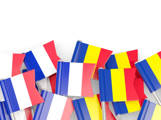 Pins with flags of France and romania isolated on white.
