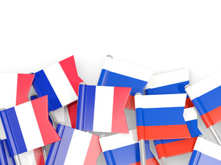 Pins with flags of France and russia isolated on white.
