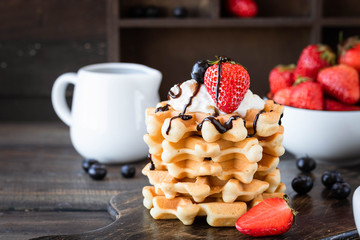 Waffles with berries and whipped cream