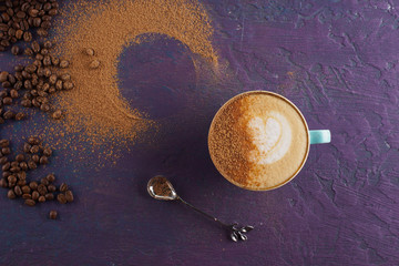 Cinnamon and coffee on a colored concrete background