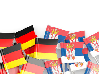Pins with flags of Germany and serbia isolated on white.