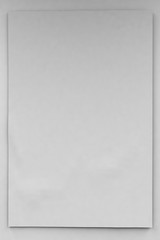 Empty vertical banner or blank of 2x3 size on a white wall. 3d illustration