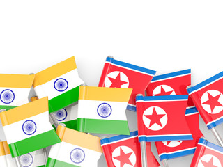 Pins with flags of India and north korea isolated on white.